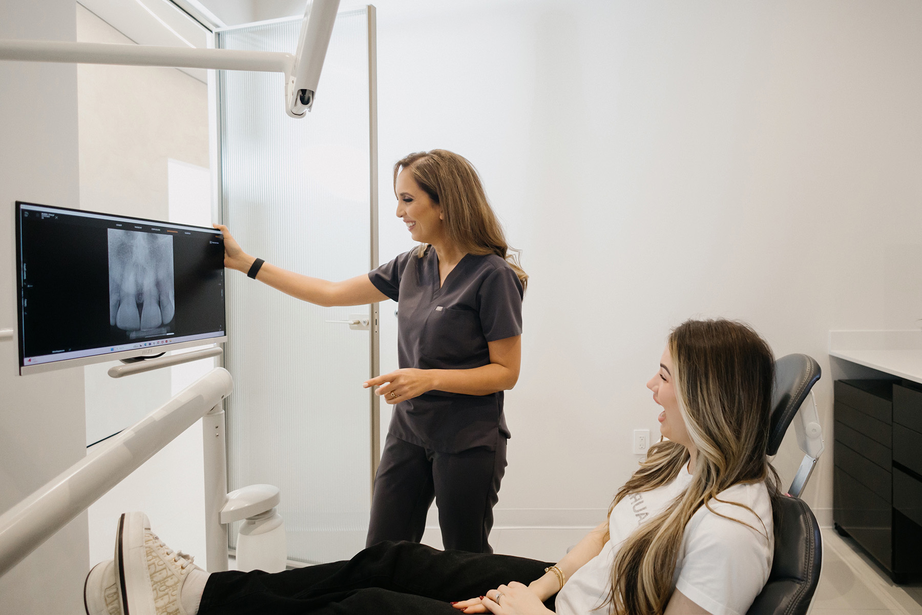 A patient reviewing her X-ray with the dentist at Clio Dental Studio in Houston Heights