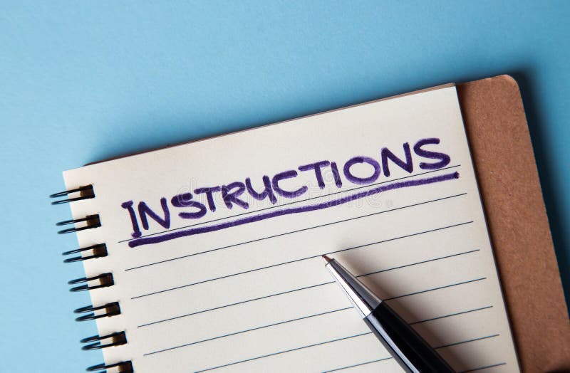Hand writing instructions on a notebook with a pen on a blue background. Writing instructions stock images, royalty-free photos and pictures