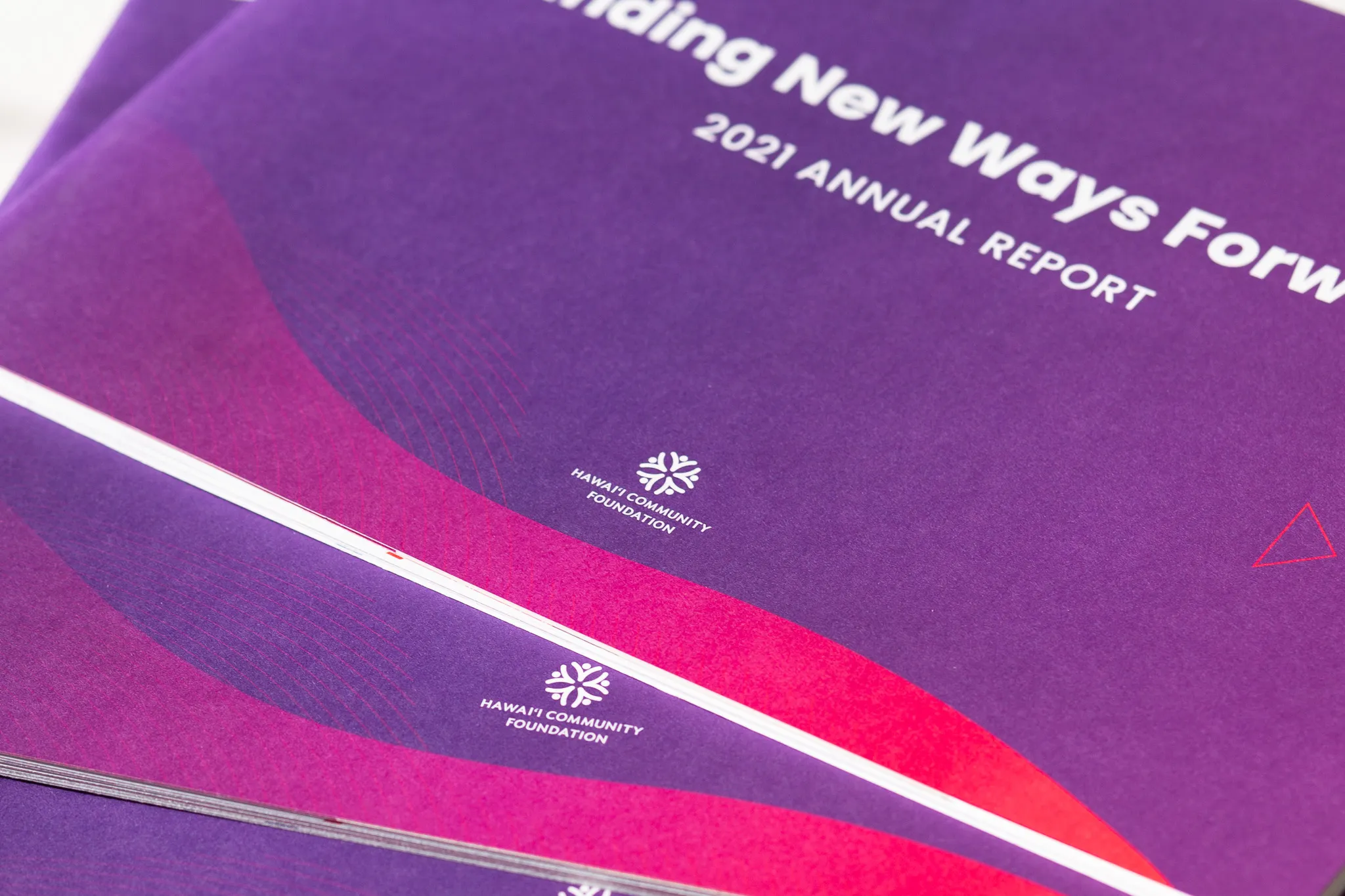 Close-up of purple 2021 annual report booklets from Hawai'i Community Foundation.