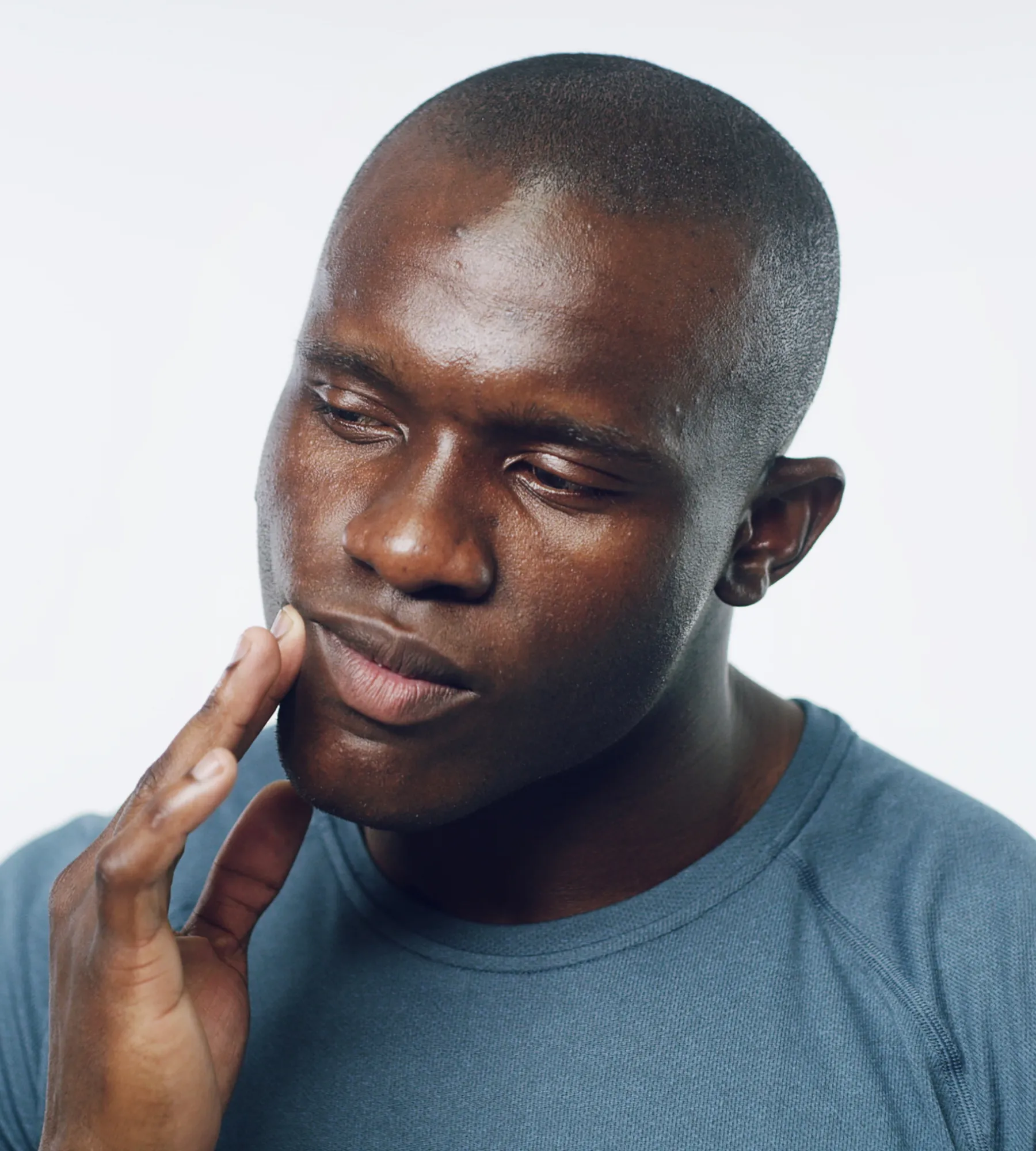 Dental hygienist showing patient information on a tablet while he sits in a dental chair.