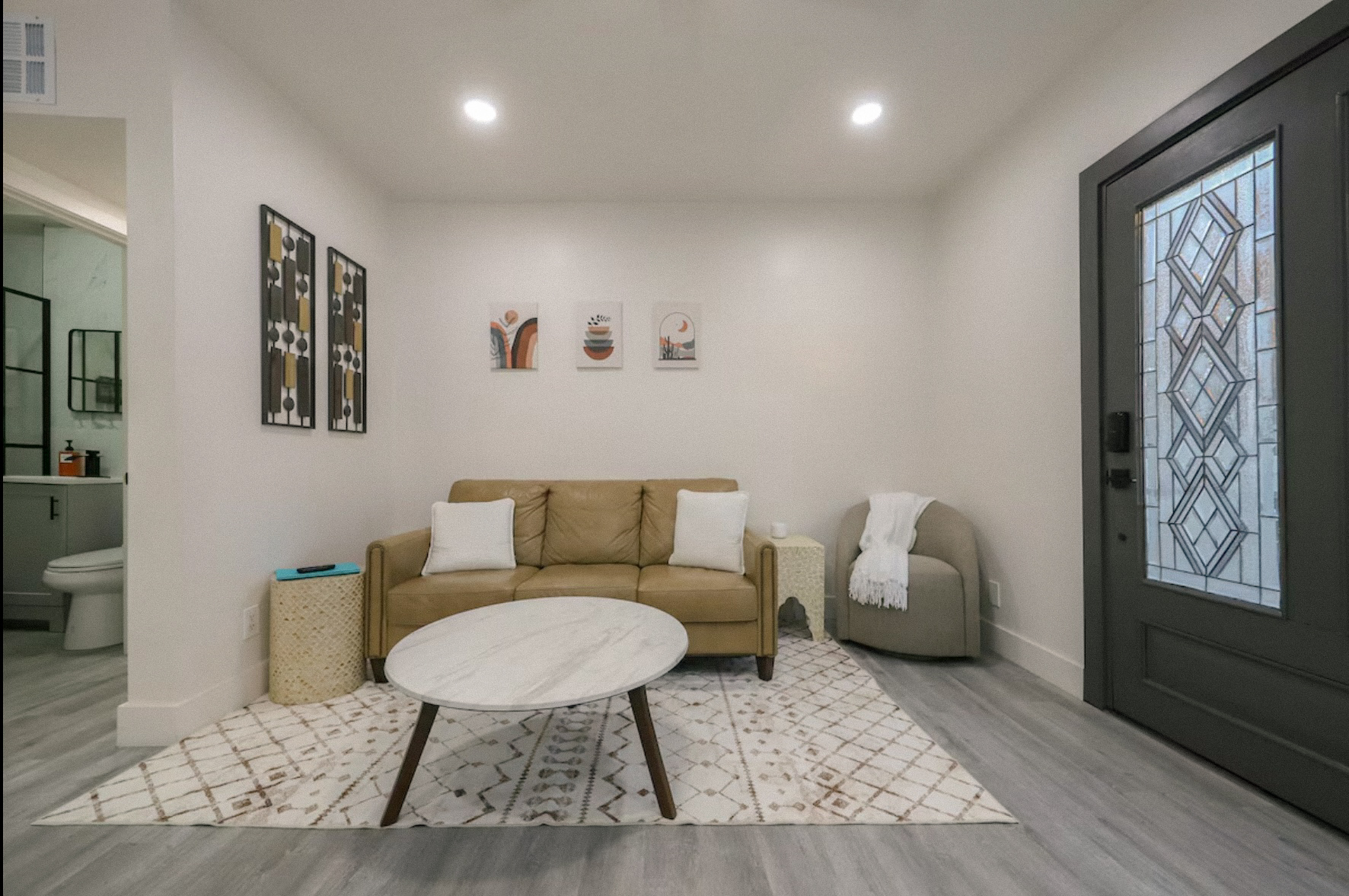 StayReady Tucson Airbnb living room with modern decor, neutral tones, and cozy seating area