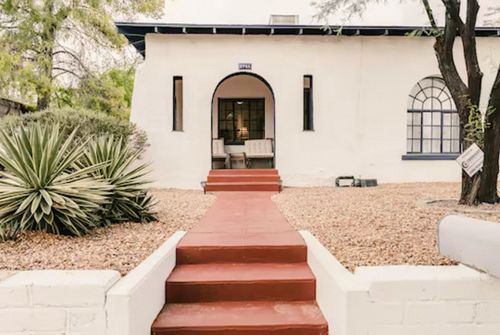 StayReady Tucson Airbnb home with desert landscaping and arched entryway