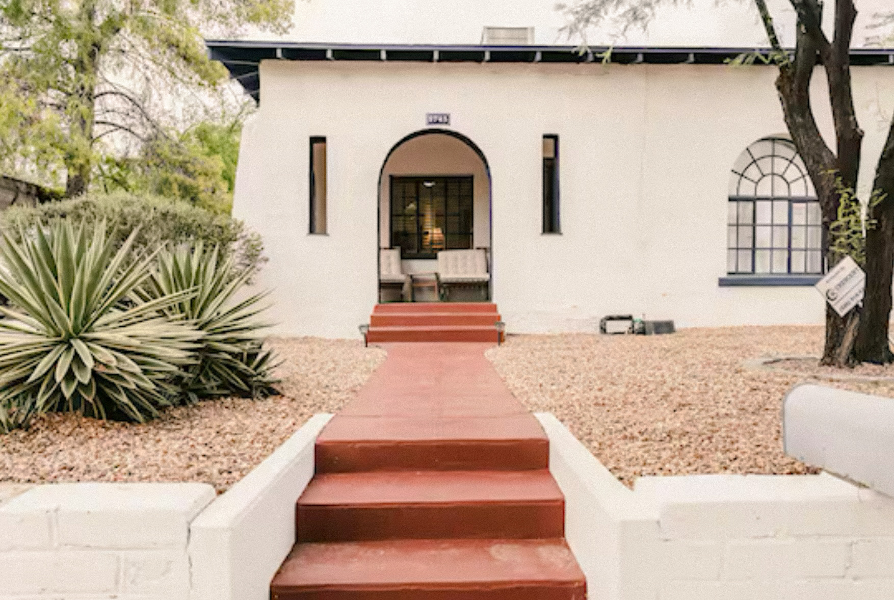 StayReady Tucson Airbnb home with desert landscaping and arched entryway
