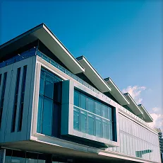 Modern commercial building with large glass facade framed in steel
