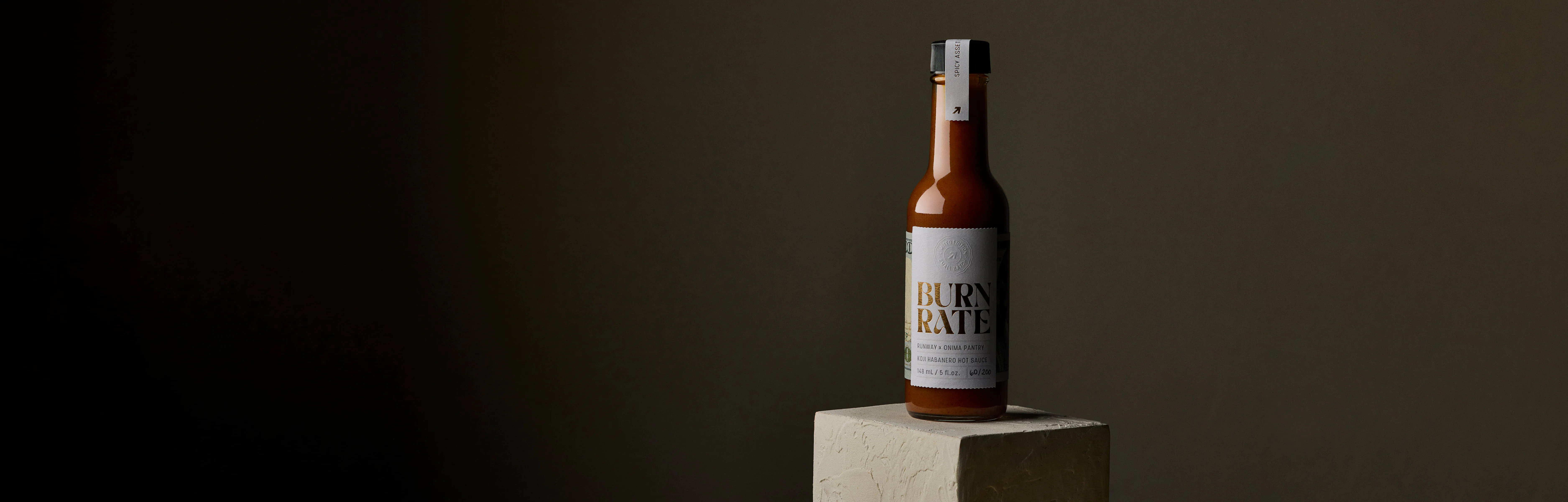 Burn Rate bottle sitting in a pedestal
