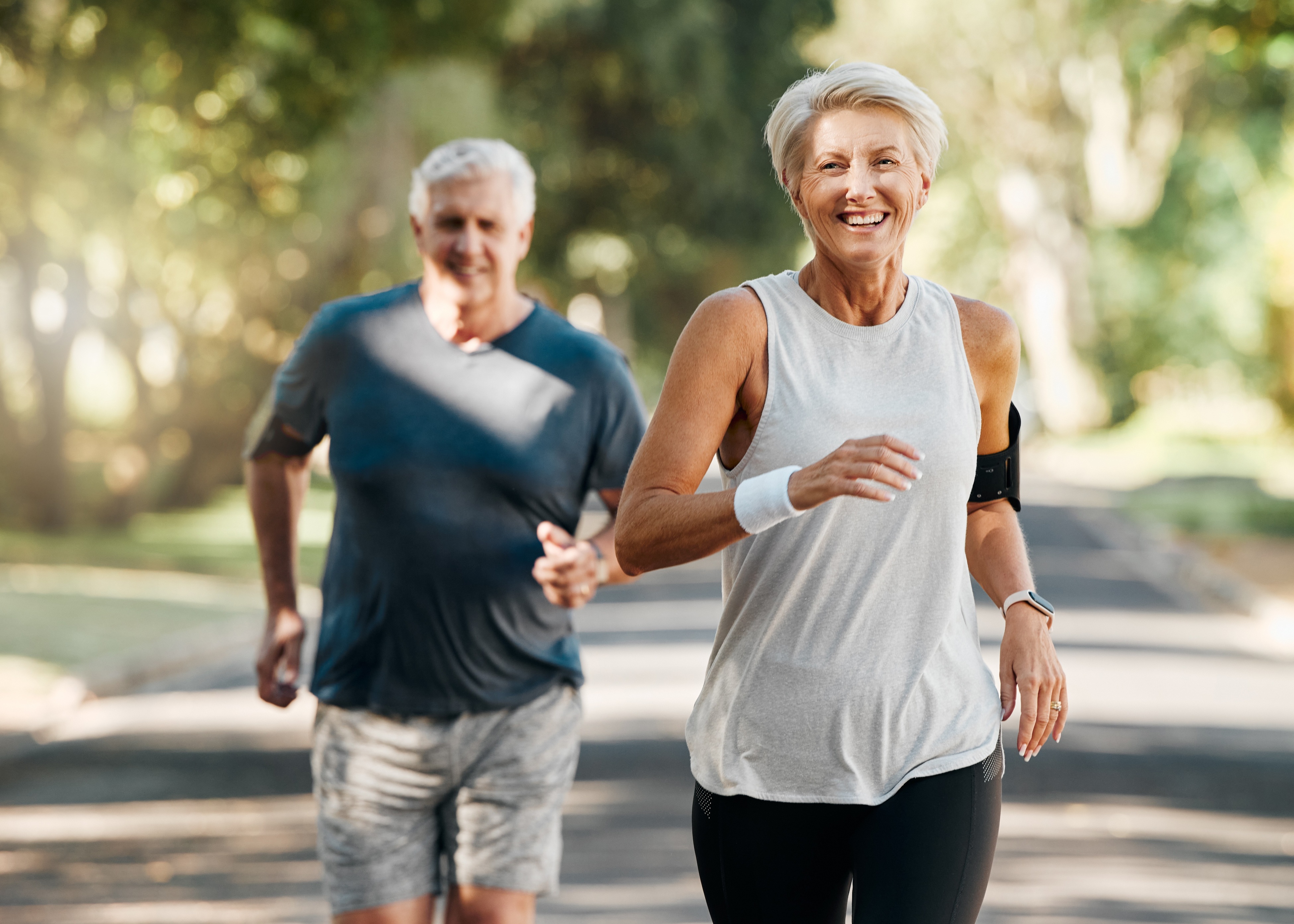 A man and a woman running down a street.