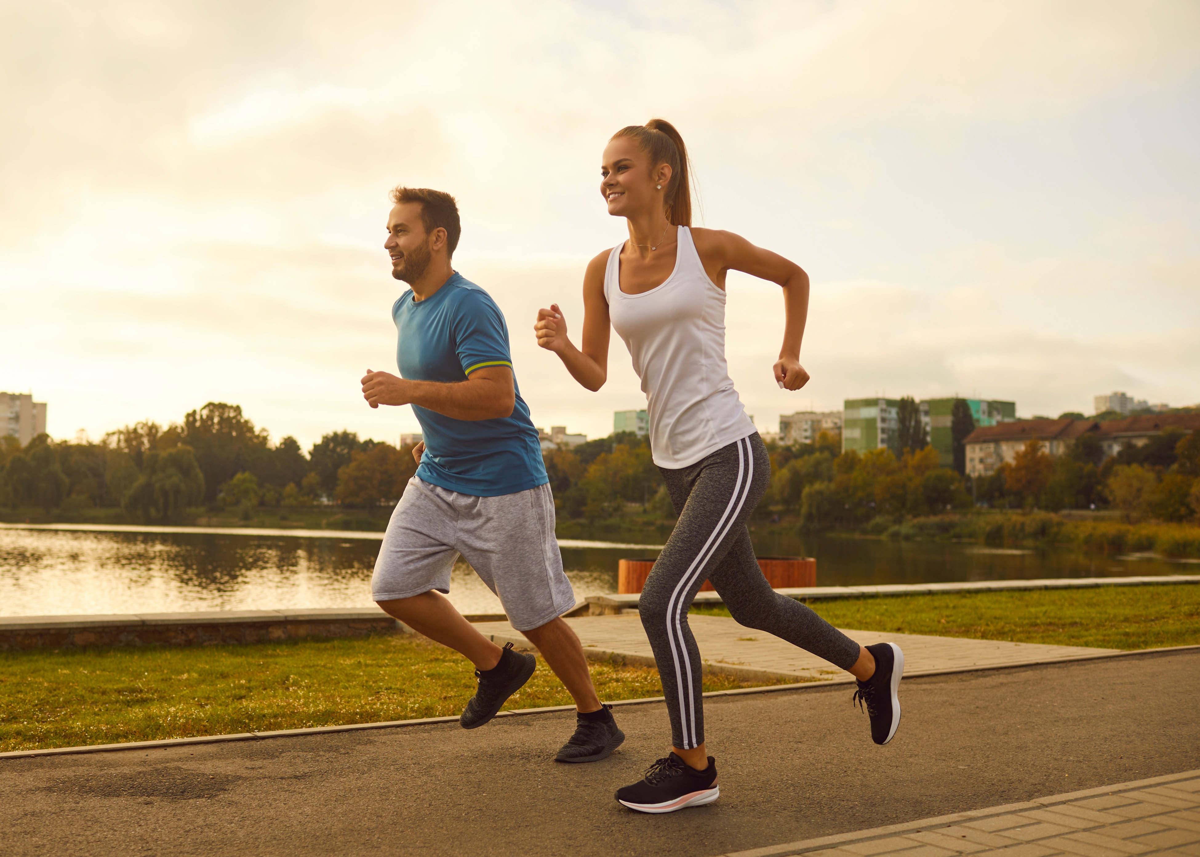 A man and a woman running down a street.