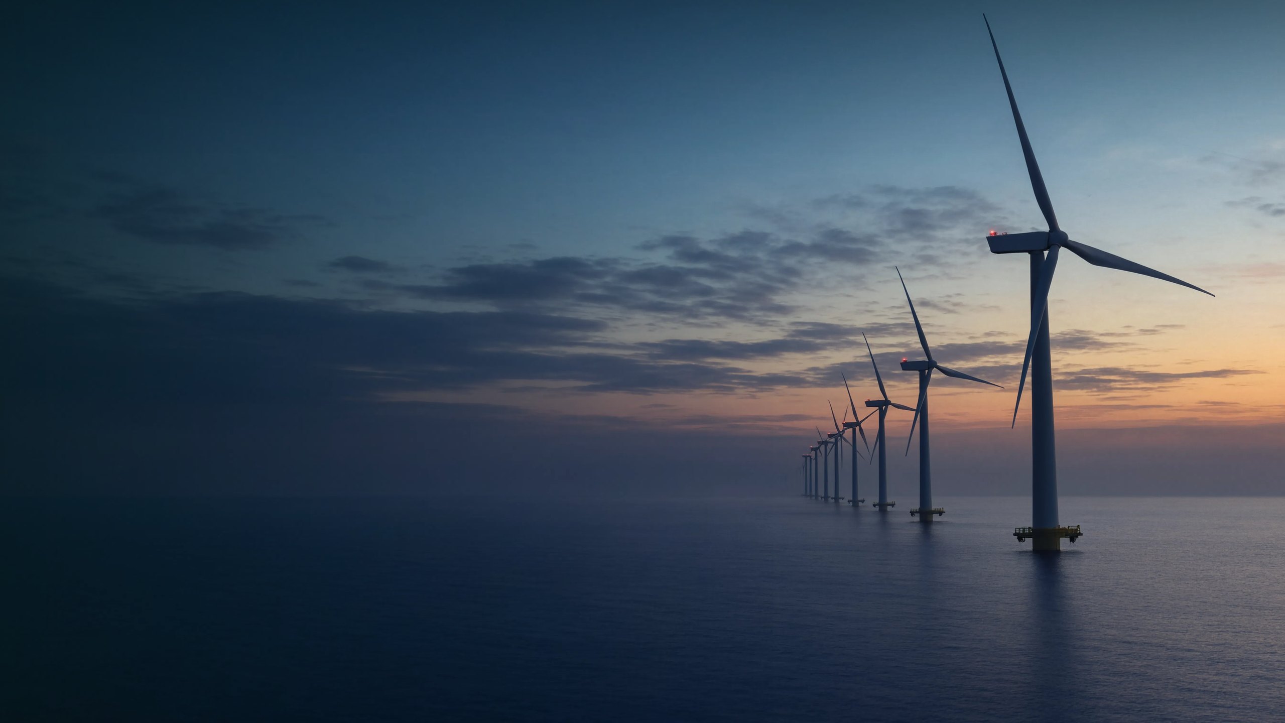 Parque eólico offshore ao anoitecer com turbinas silhuetadas, planejamento net zero