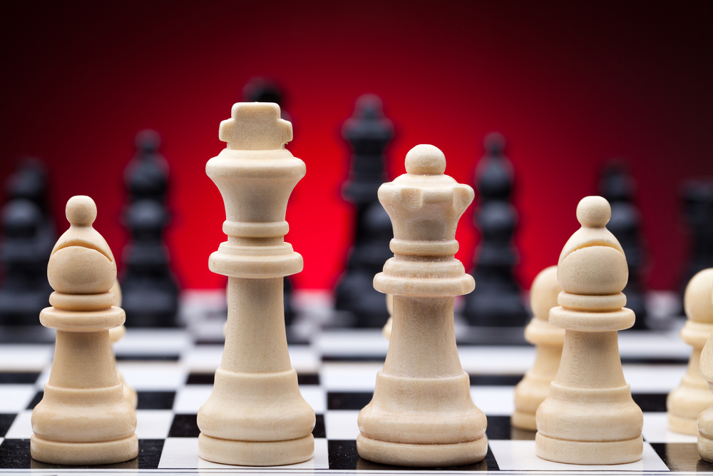 Chess pieces on a board representing long-term planning and finding betting leaks in sports