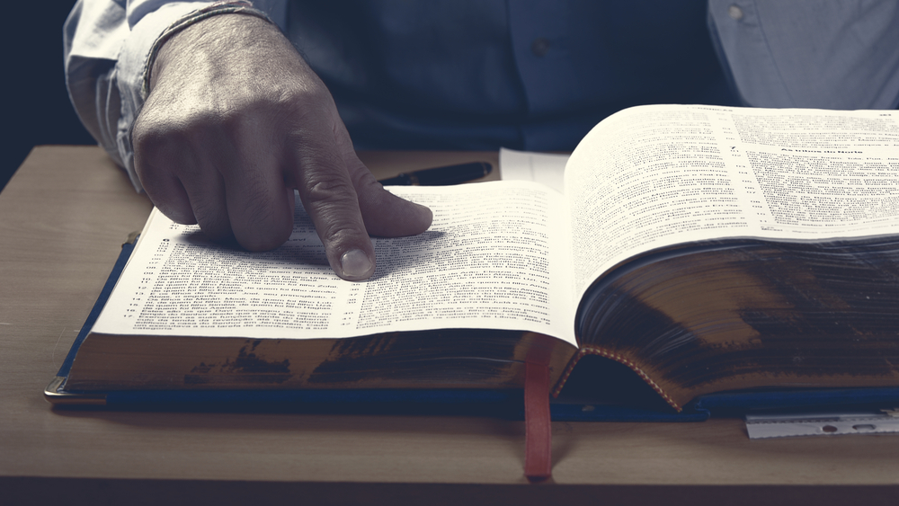 A man scans a glossary