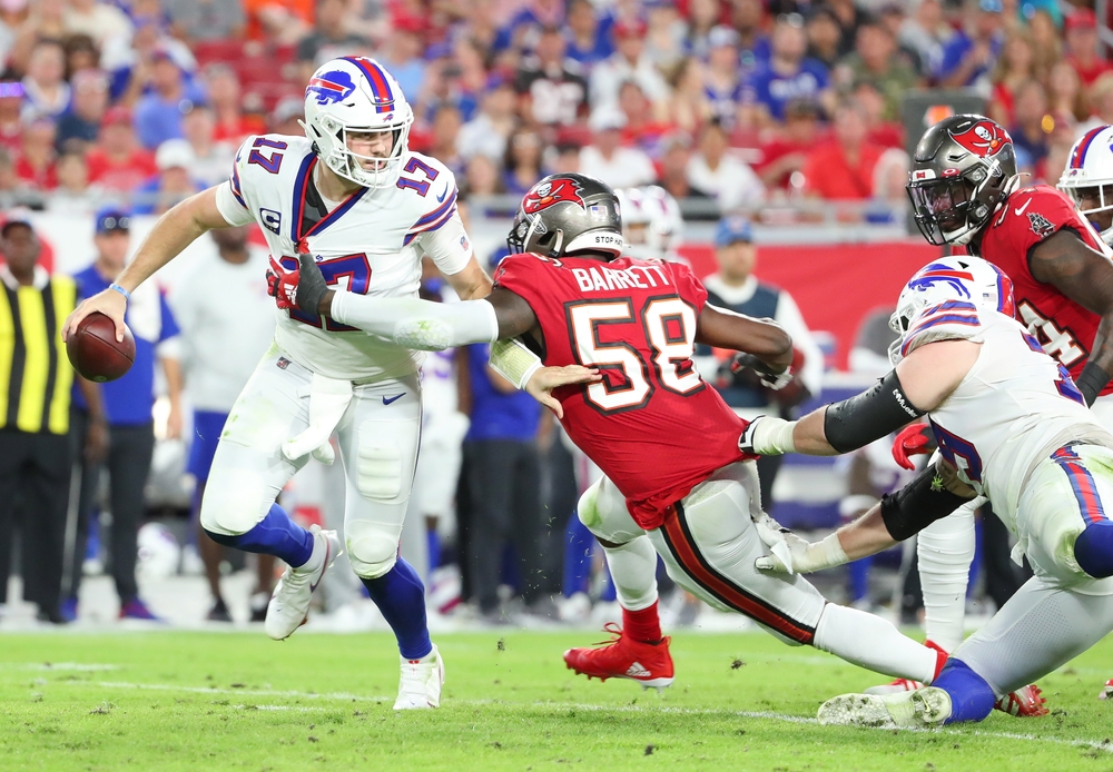 Josh Allen scrambles with the football