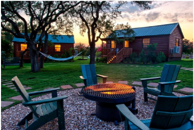 Cabin rentals in Austin with fire pit and outdoor seating area at sunset