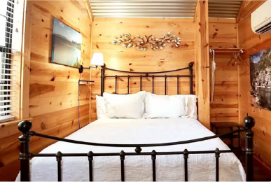 Austin cabin bedroom with comfortable bed and rustic wooden design