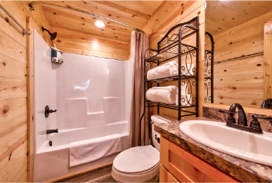 Private bathroom inside Texas cabin rental with shower and wooden design