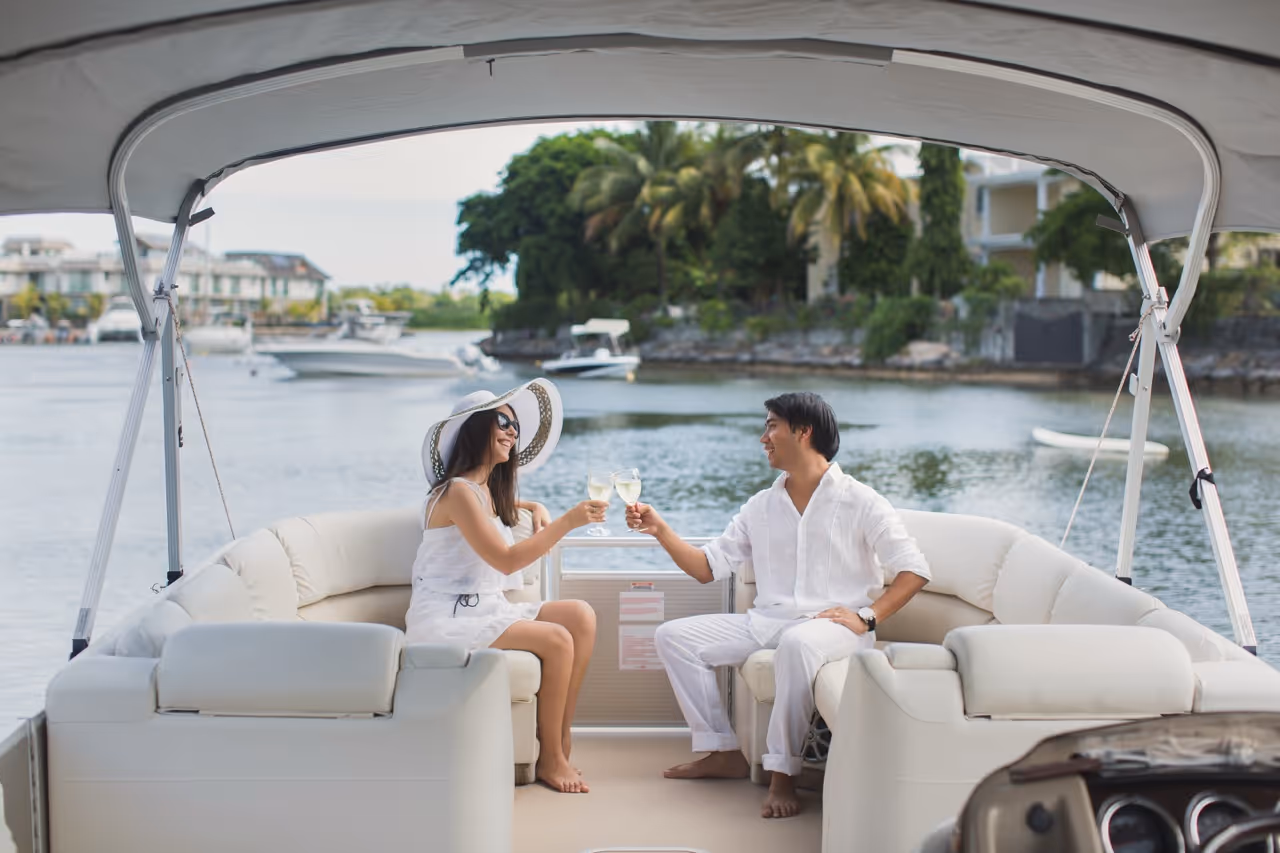 Smiling Couple Cheering with Champagne on Yacht