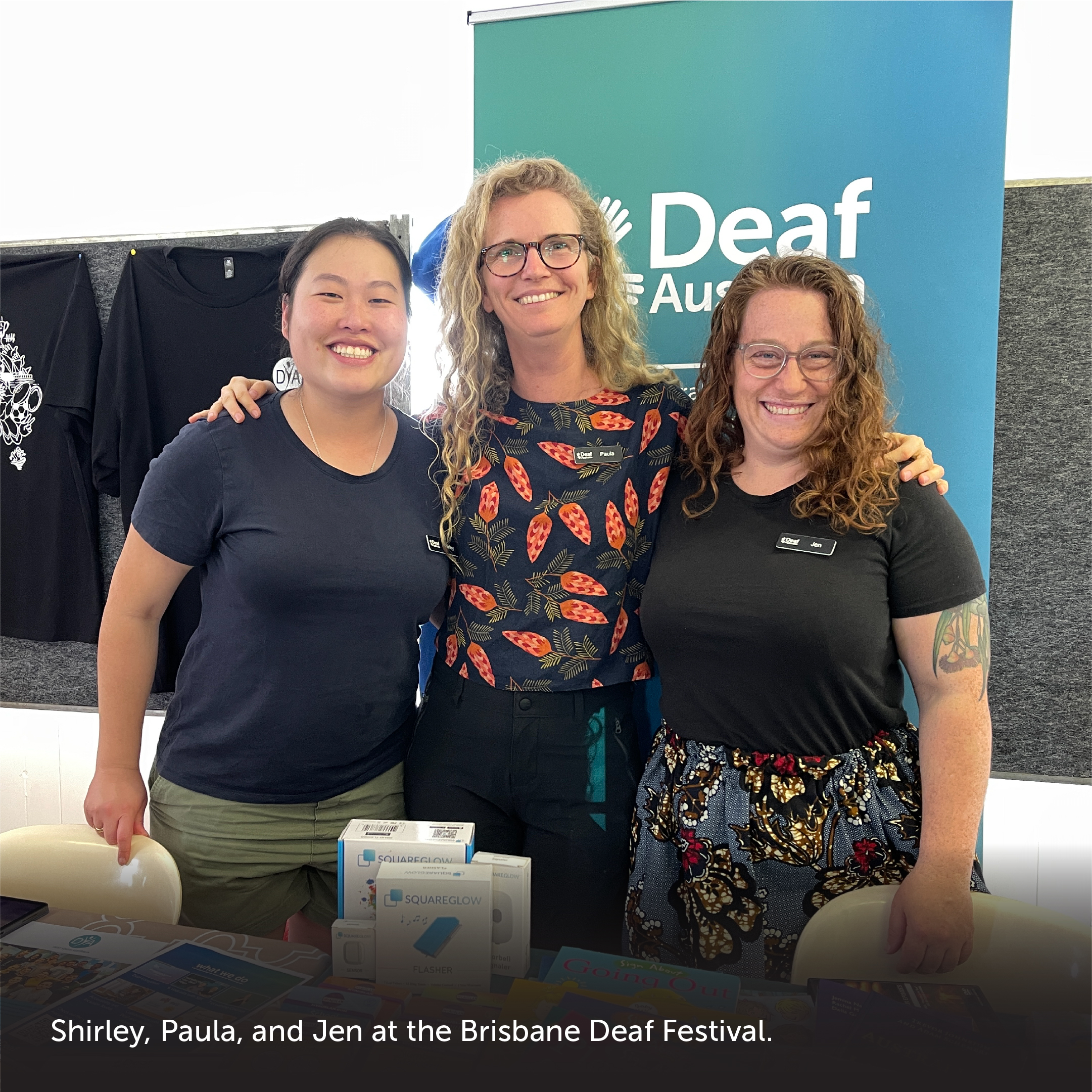 Slide 5: Photograph with caption at the bottom. Features three women standing in front of a Deaf Australia sign. Caption: 'Shirley, Paula, and Jen at the Brisbane Deaf Festival.'