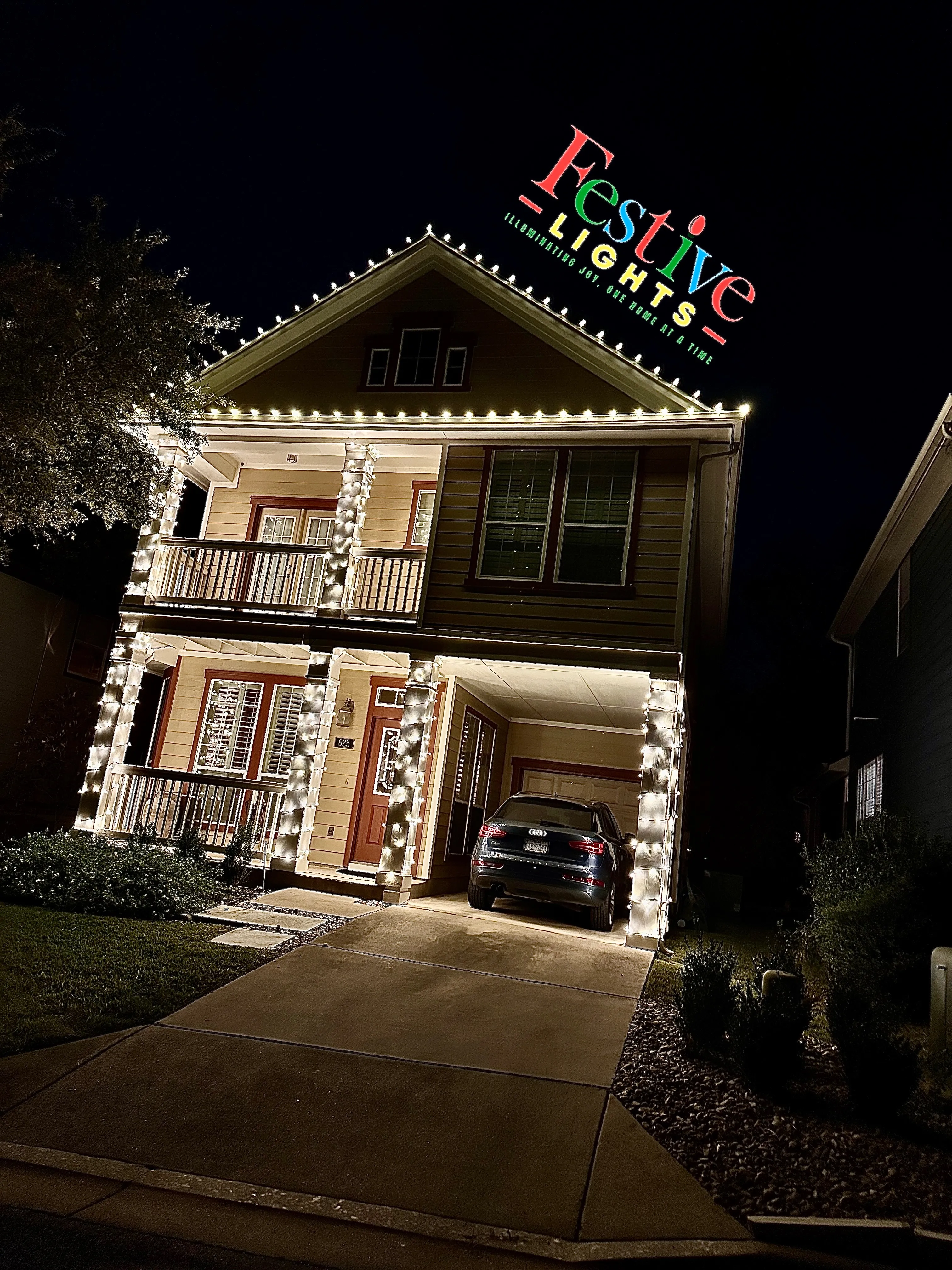 A house with garage that is decorated with lights.