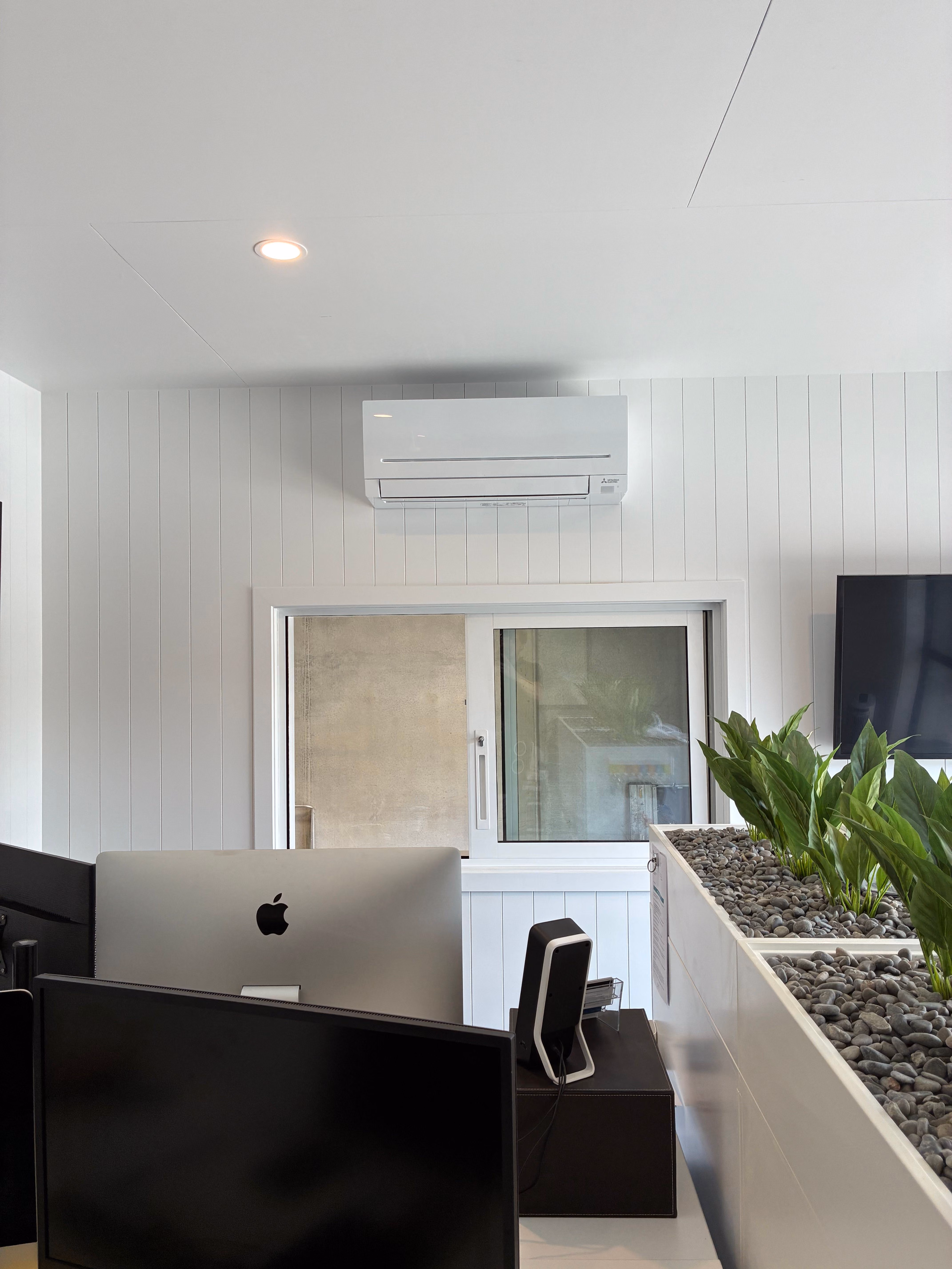 An image of a Mitsubishi Electric AP35 high wall heat pump installed in a Tauranga office