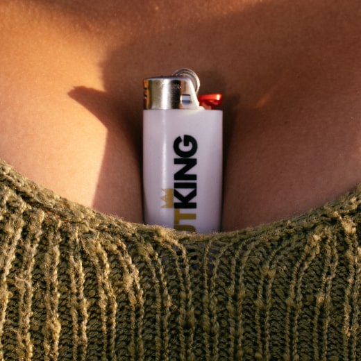 A woman's cleavage with a lighter tucked into it