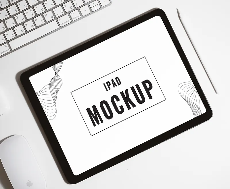 Tablet mockup placed on a white desk next to a keyboard.