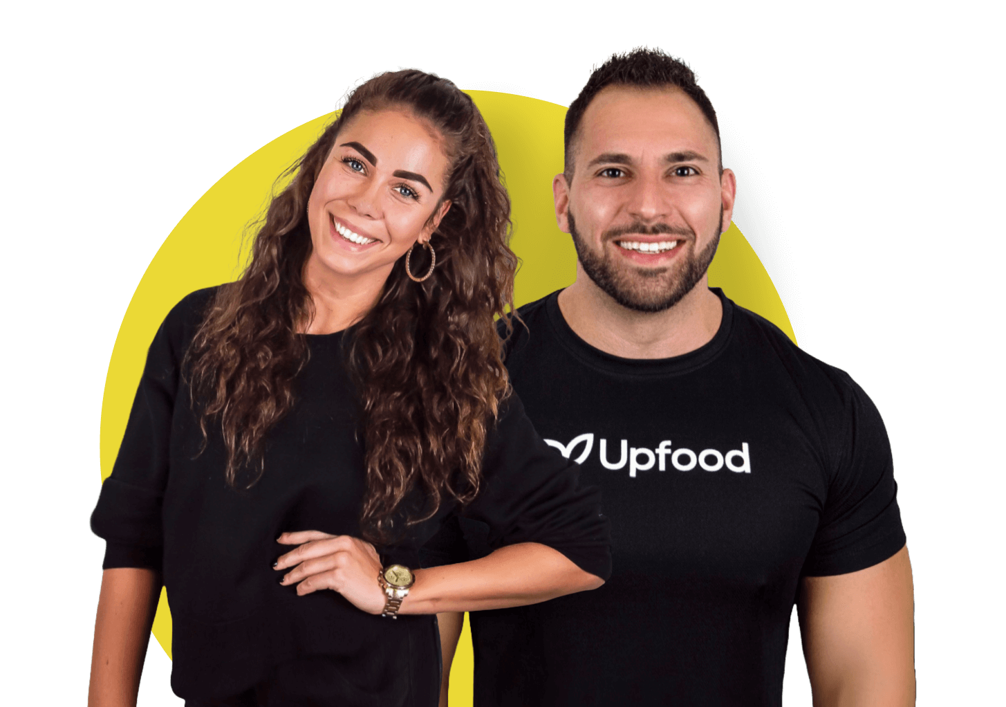 Smiling woman with curly hair wearing a black long-sleeve top and a man with short hair and beard wearing a black Upfood t-shirt, posed in front of a yellow circle background.