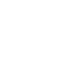 A cookie with a bitten corner and some crumbles laying around. 
