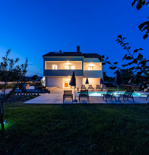 Photo of the house from the ground, at night