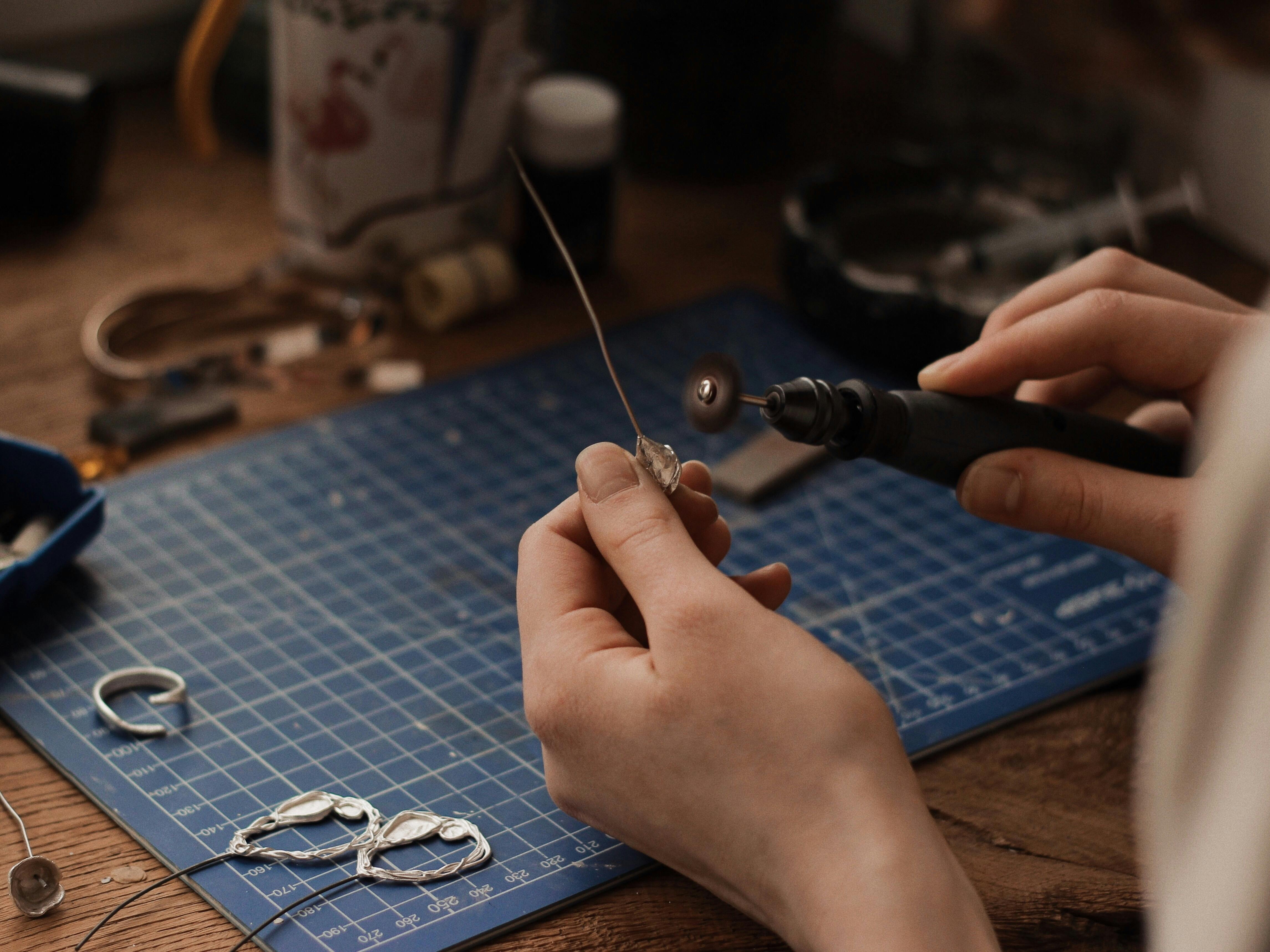 A jeweler hand polishing a bracelet