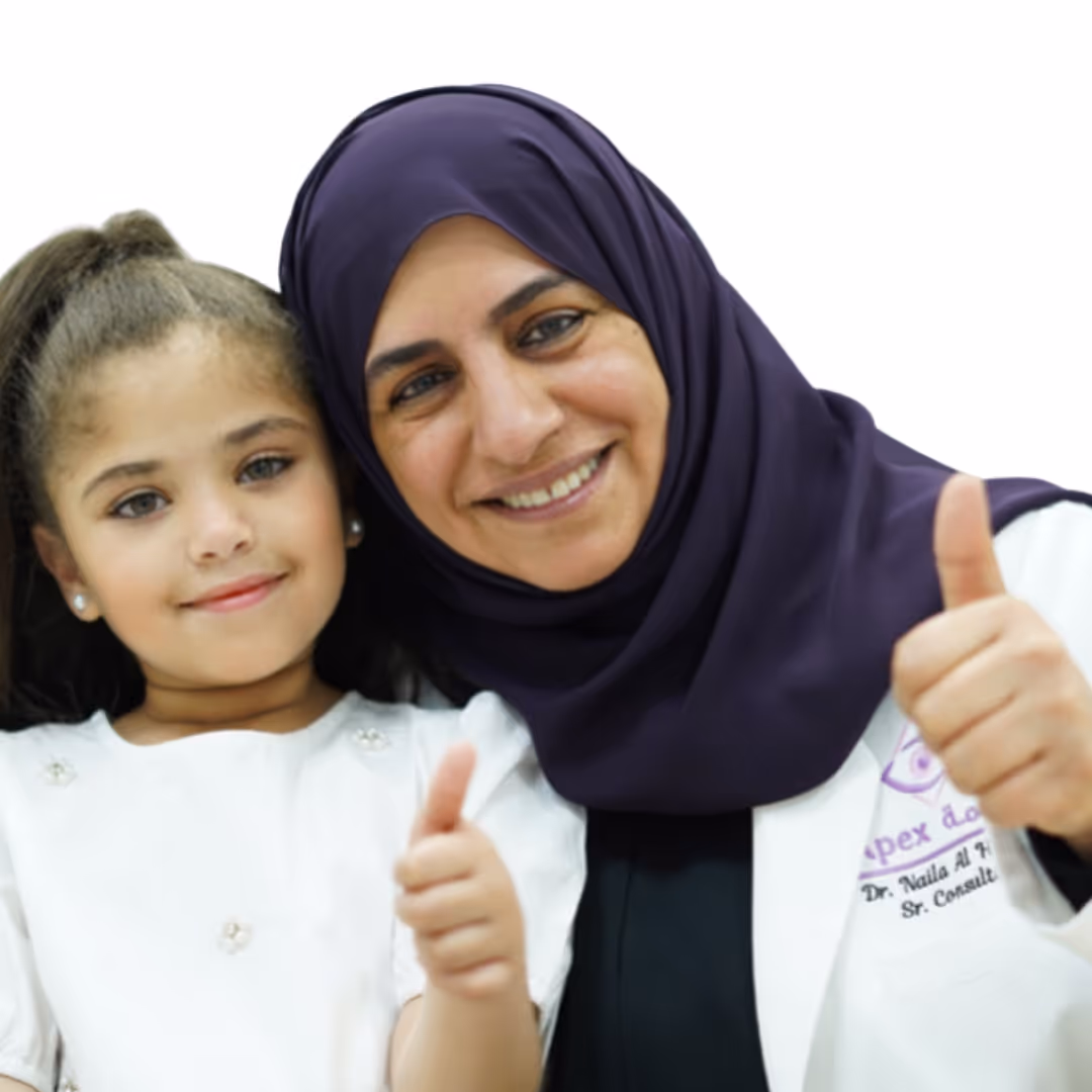 A smiling woman in a dark hijab and white coat with a young girl, both giving thumbs-up.