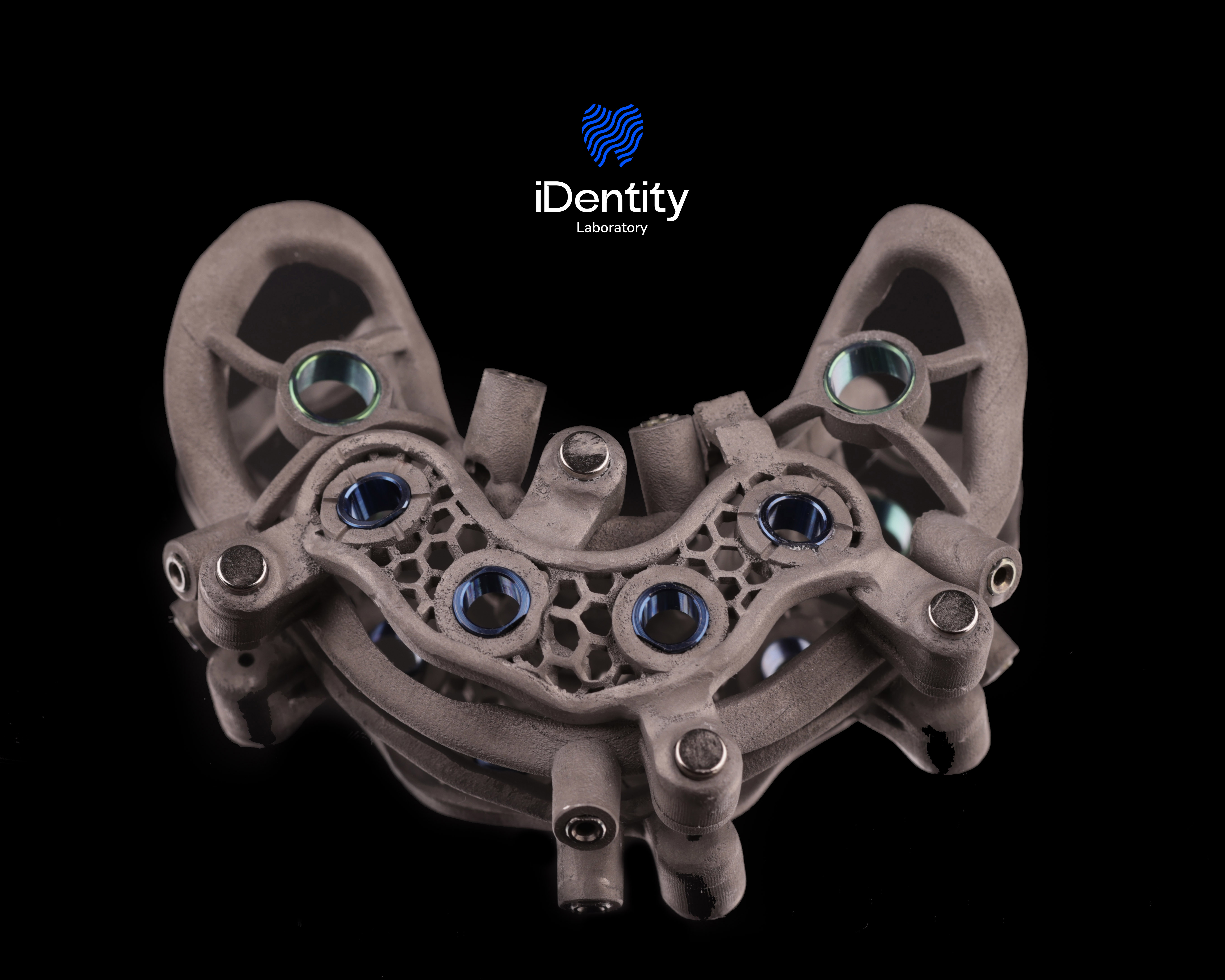 Metal surgical guide with multiple holes and a honeycomb pattern on a black background.