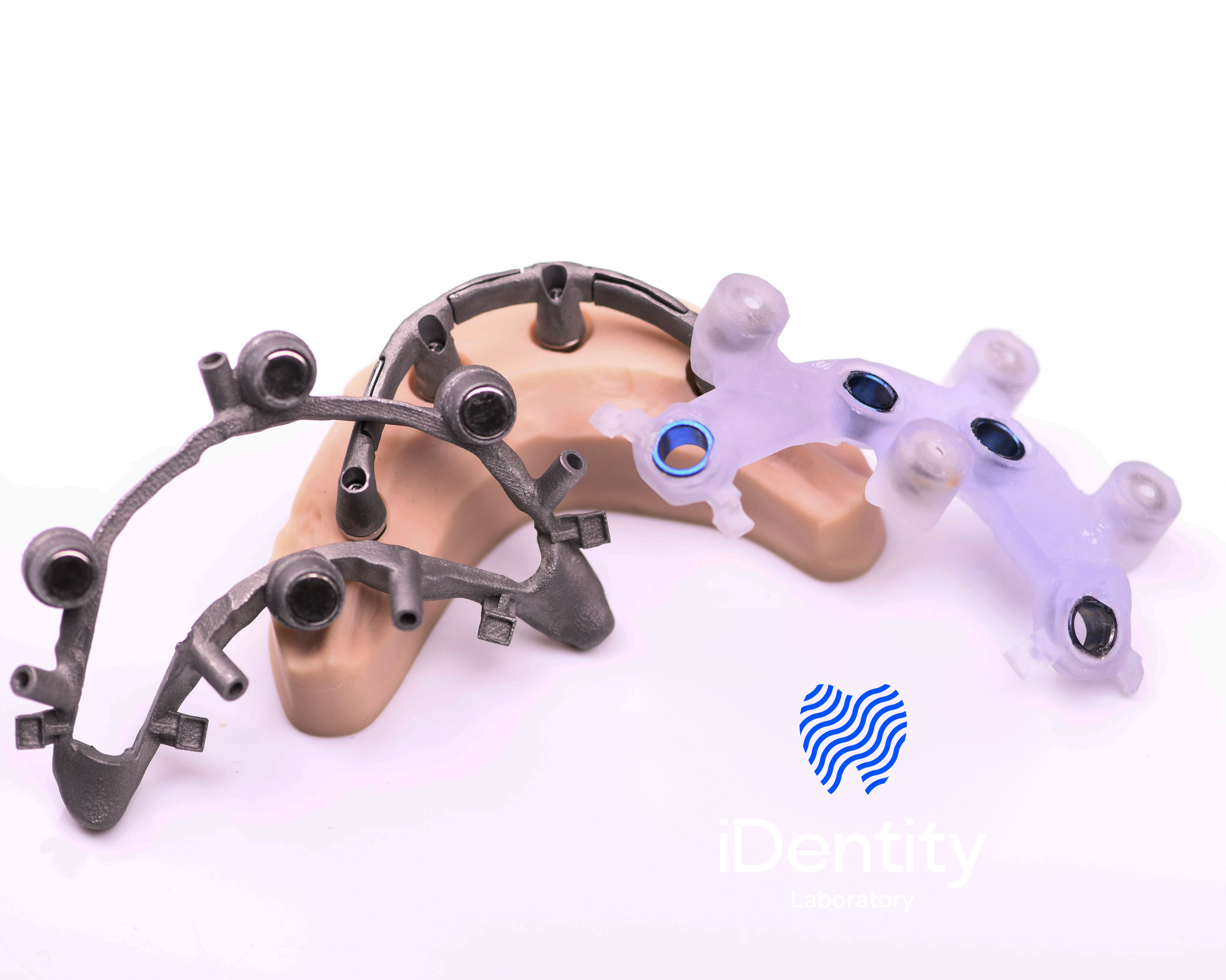 Dental surgical guides and metal frameworks placed on a model of the upper jaw.