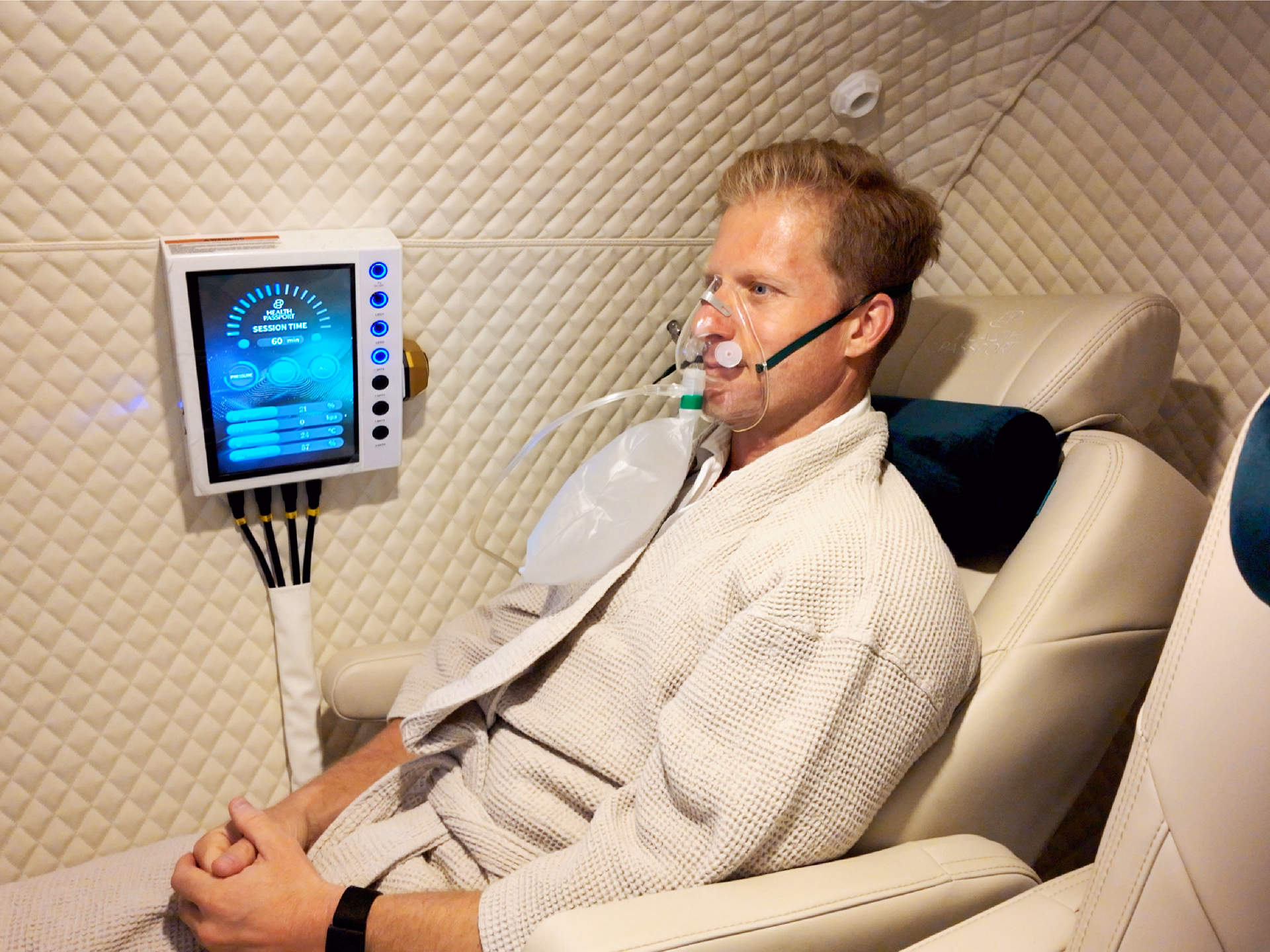 Patient receiving Hyperbaric Oxygen Therapy (HBOT) in a private luxury treatment chamber at Health Passport Bangkok.