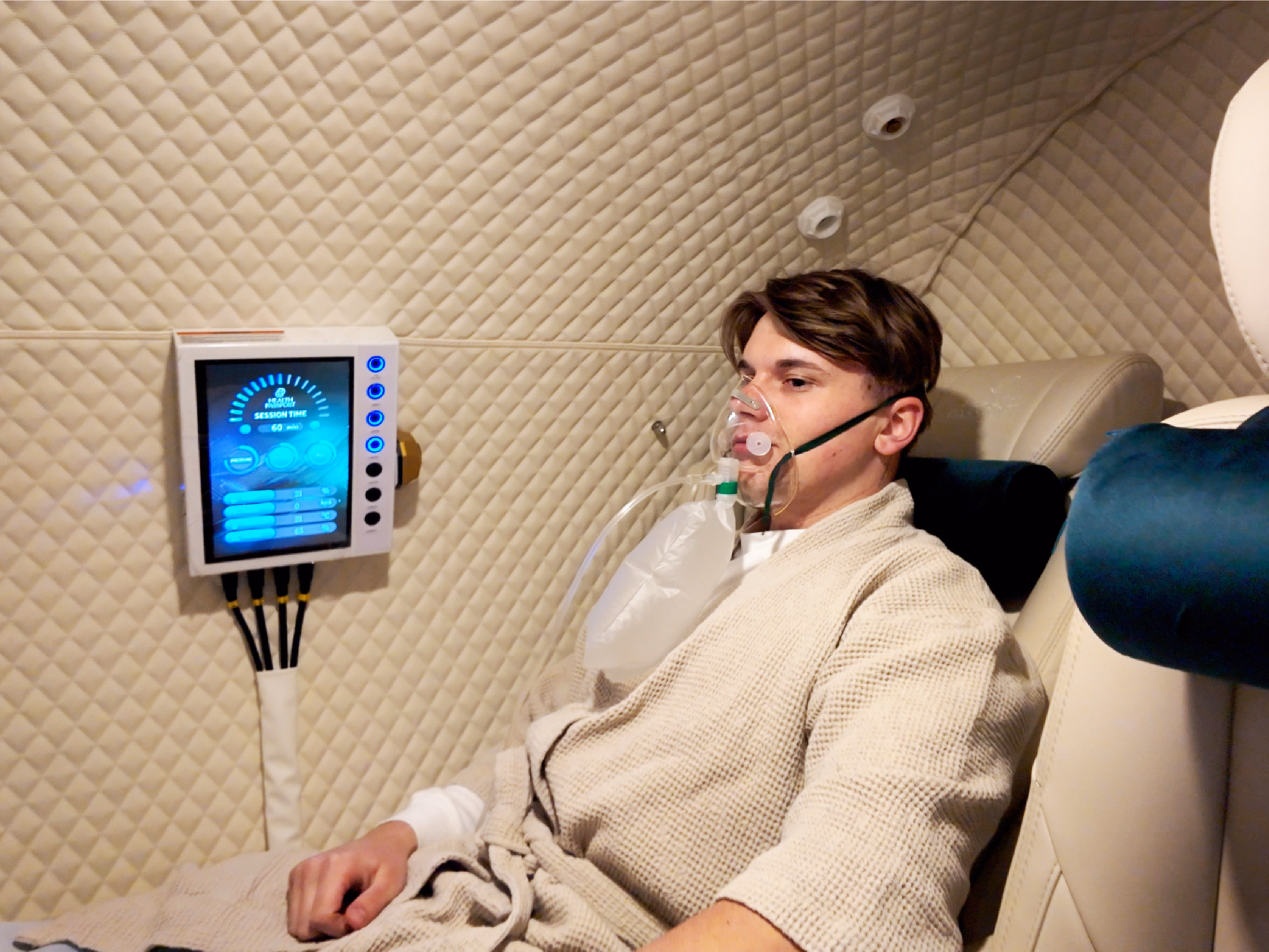 Patient receiving Hyperbaric Oxygen Therapy (HBOT) in a private luxury treatment chamber at Health Passport Bangkok.