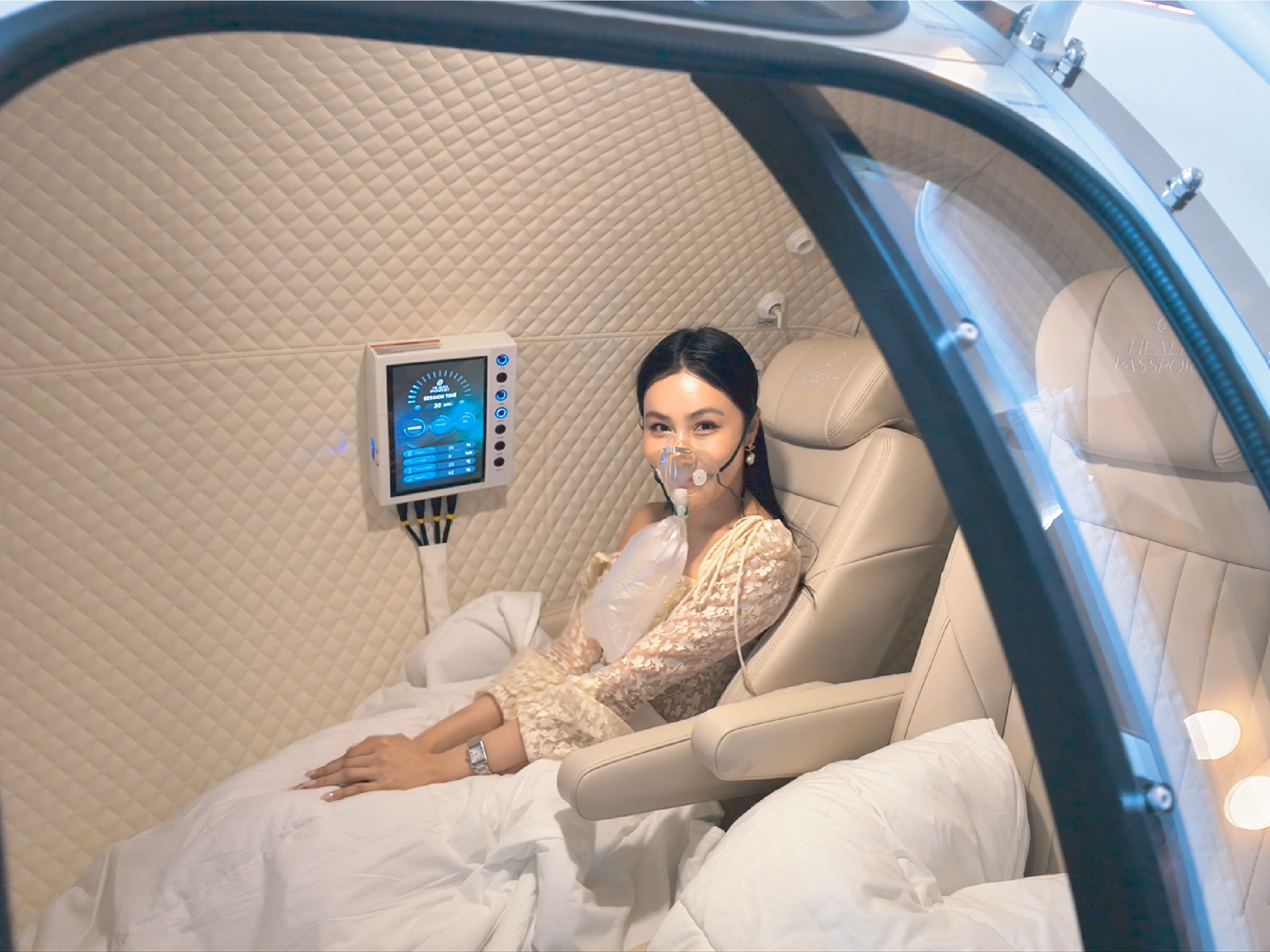 Patient receiving Hyperbaric Oxygen Therapy (HBOT) in a private luxury treatment chamber at Health Passport Bangkok.
