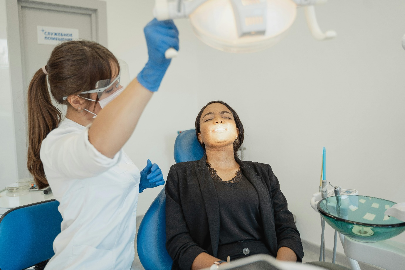 A medical assistant is assisting her patient in a dental clinic