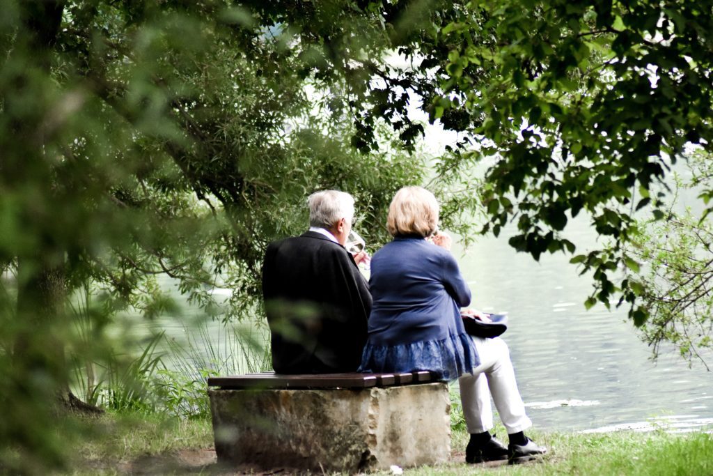 older couple sitting on a bench