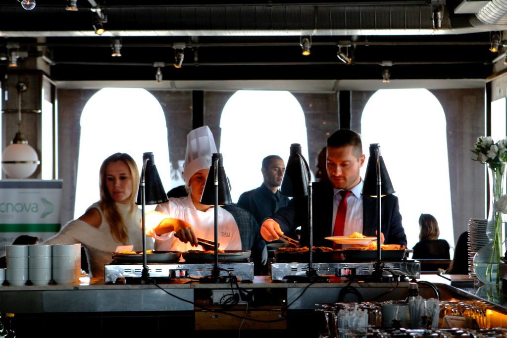 wedding guests grabbing food from a buffet