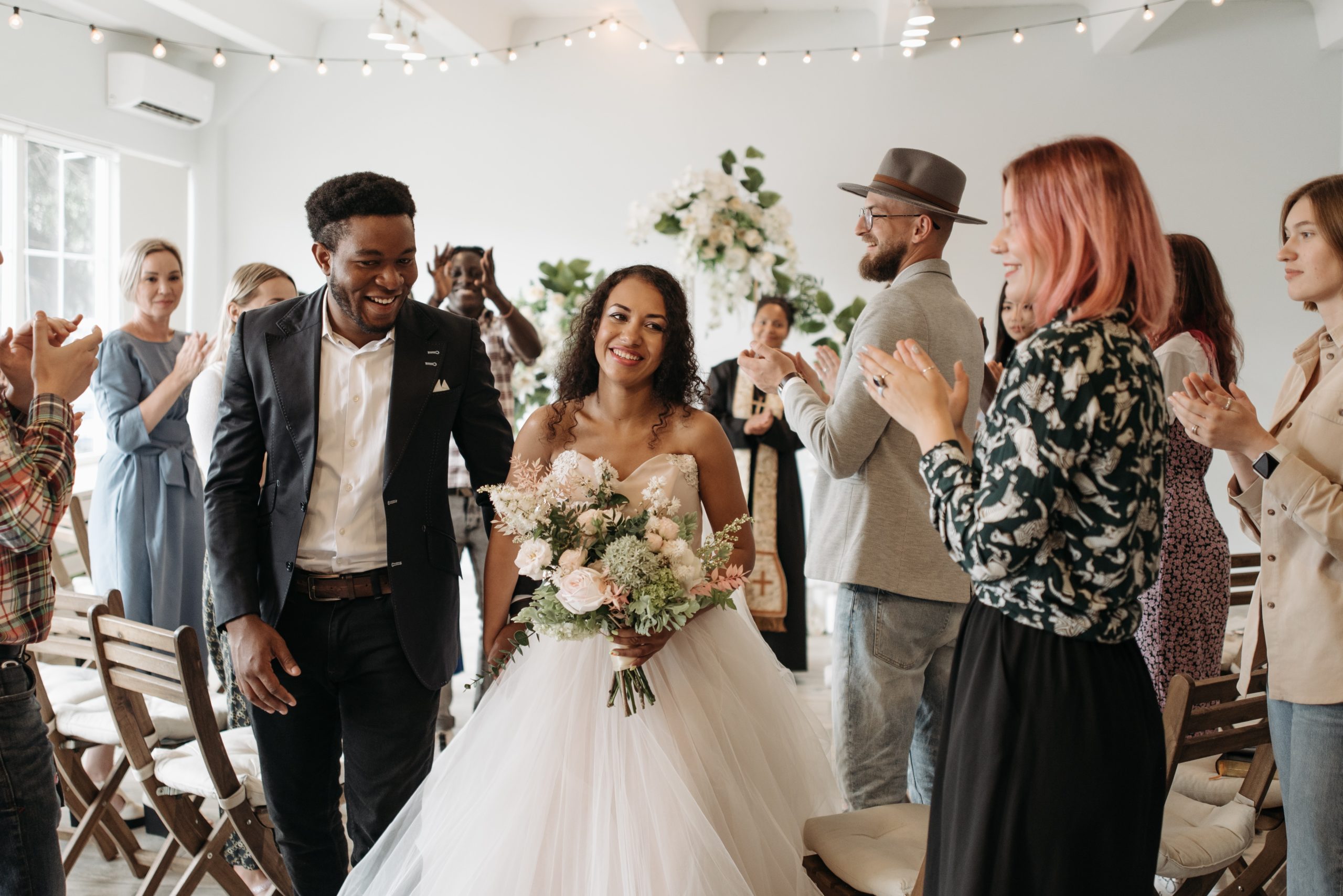 wedding guests clapping for newlyweds