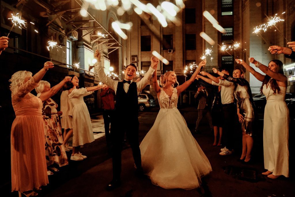 newlyweds walking with firecrackers after successful marriage license