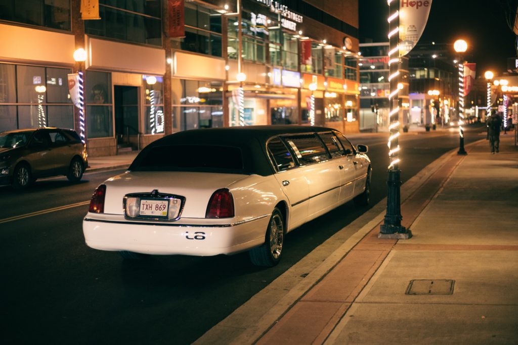 wedding limo waiting outside wedding reception for transportation