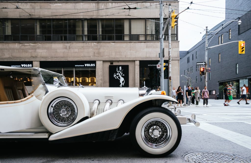 white vintage wedding car transportation