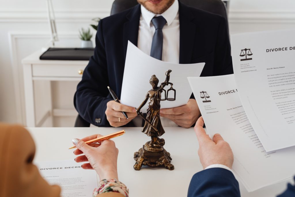 signing divorce papers with a lawyer