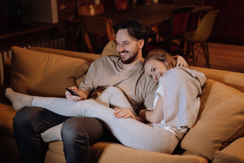 couple watching a movie effectively managing their conflicts During The Wedding Planning Process