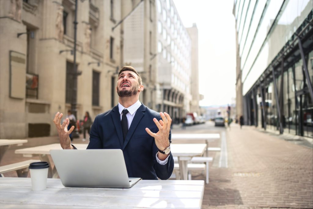 man sitting in front of the computer managing stress for his wedding edition