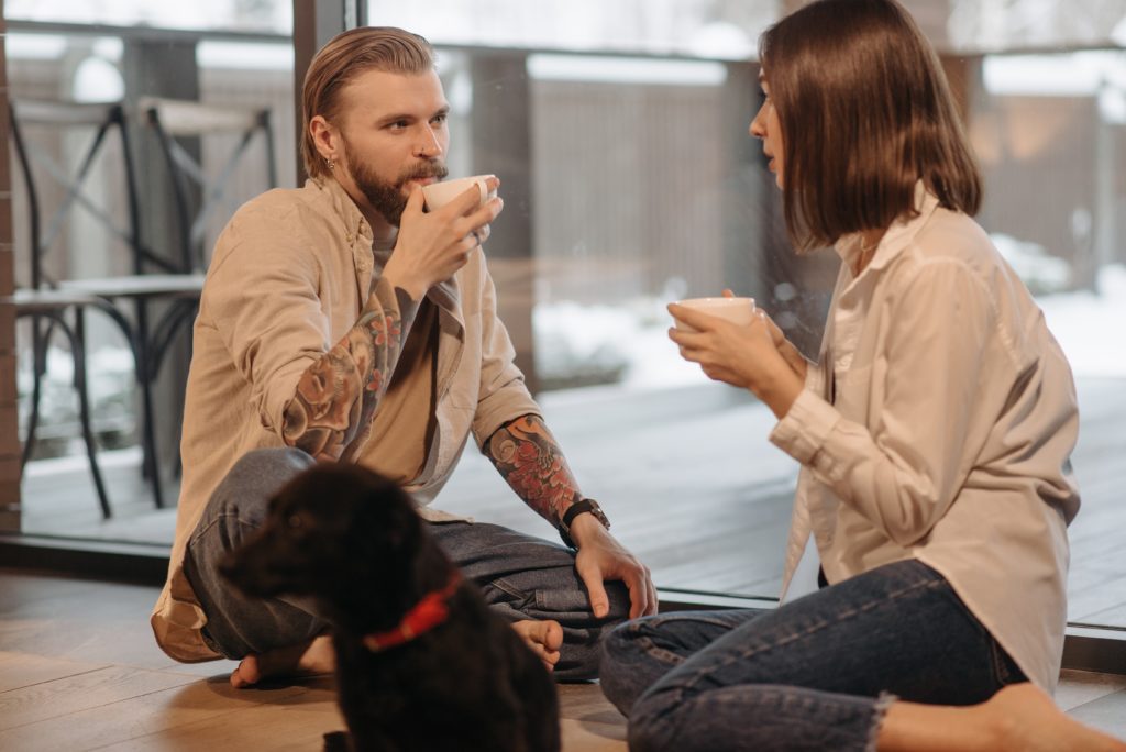 couple drinking coffee talking about their prenuptial negotiation
