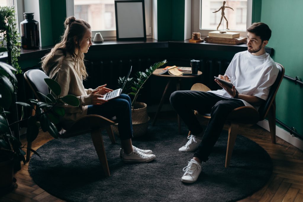 couple in the office talking if they really need a prenup