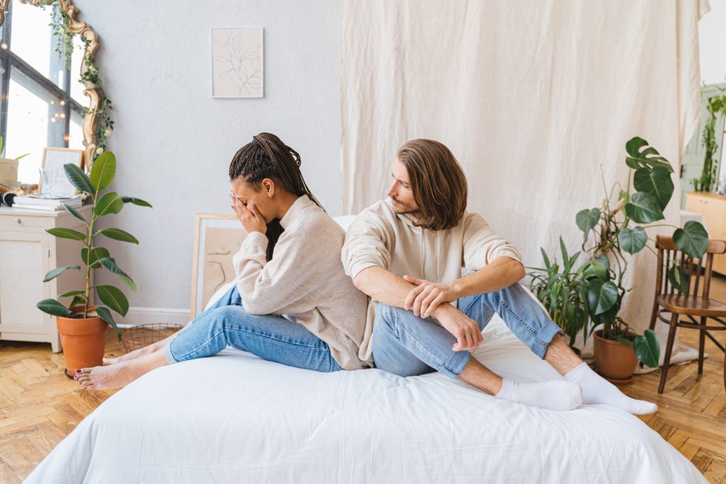 couple in bed arguing Are Prenups Useless? Debunking Common Misunderstandings