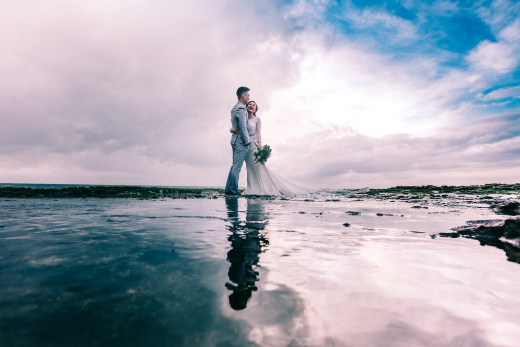 couple in the middle of the beach How Can We Ensure Our Wedding Day Goes Smoothly?