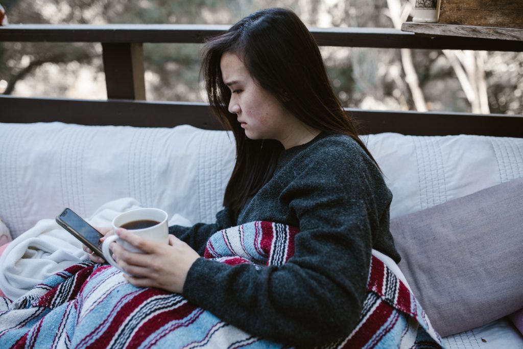 How Technology Has Revolutionized Infidelity: The Impact of Social Media and Dating Apps on Cheating woman worried about what she sees on her cell phone
