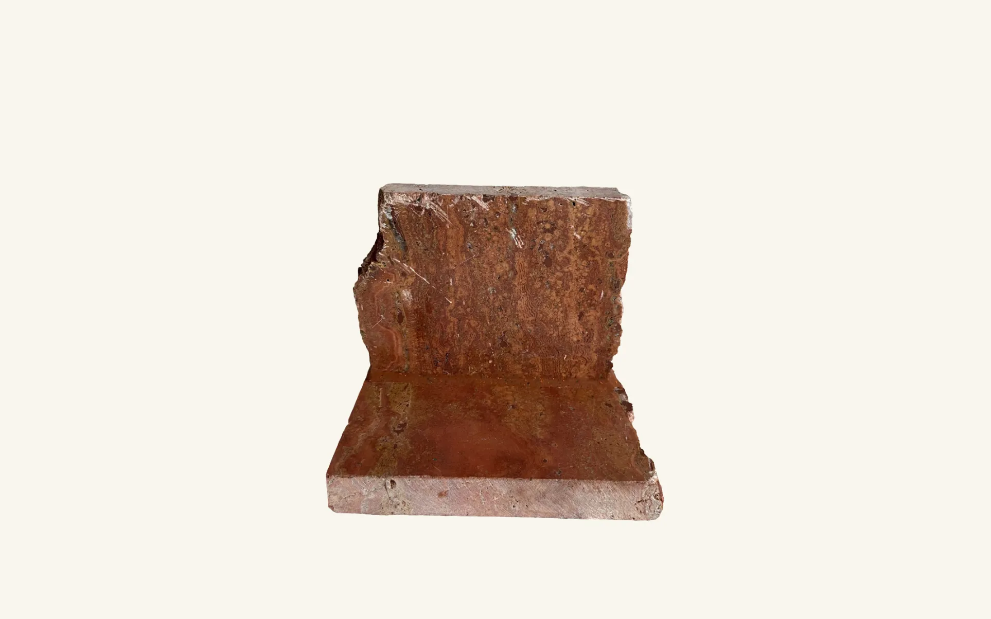 Rosso travertine surface featuring FugeMads Stone Echo veined silicone sealant